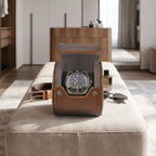 Small vintage brown leather watch roll on a dressing room bench, highlighting its craftsmanship and compact size for travel storage.