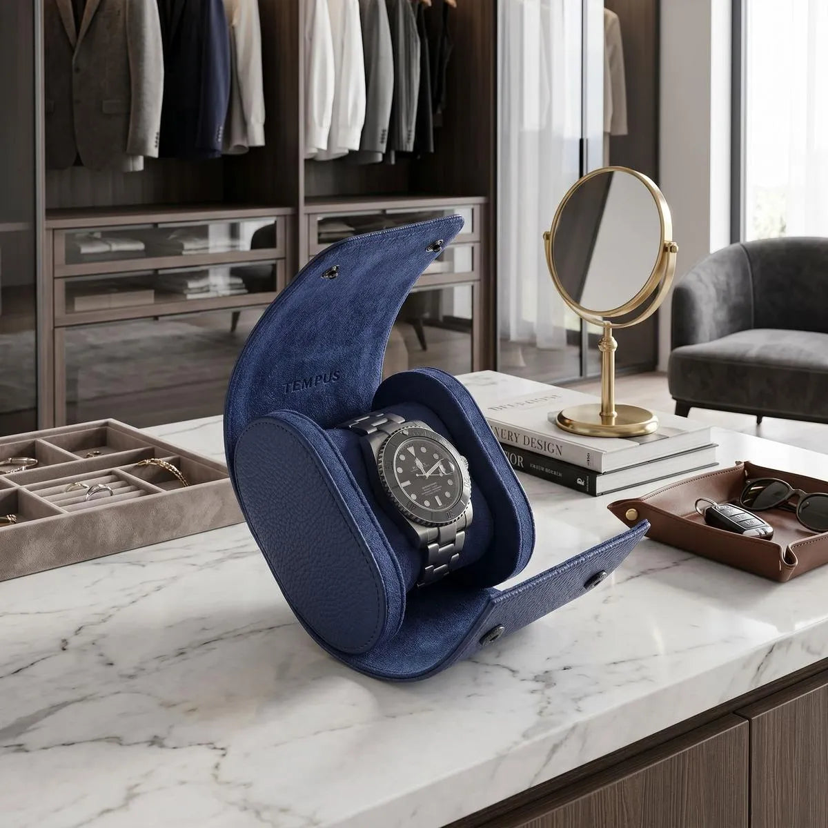 Premium blue vegan leather watch roll with suede lining displayed in a bright, modern walk-in closet with luxury props.