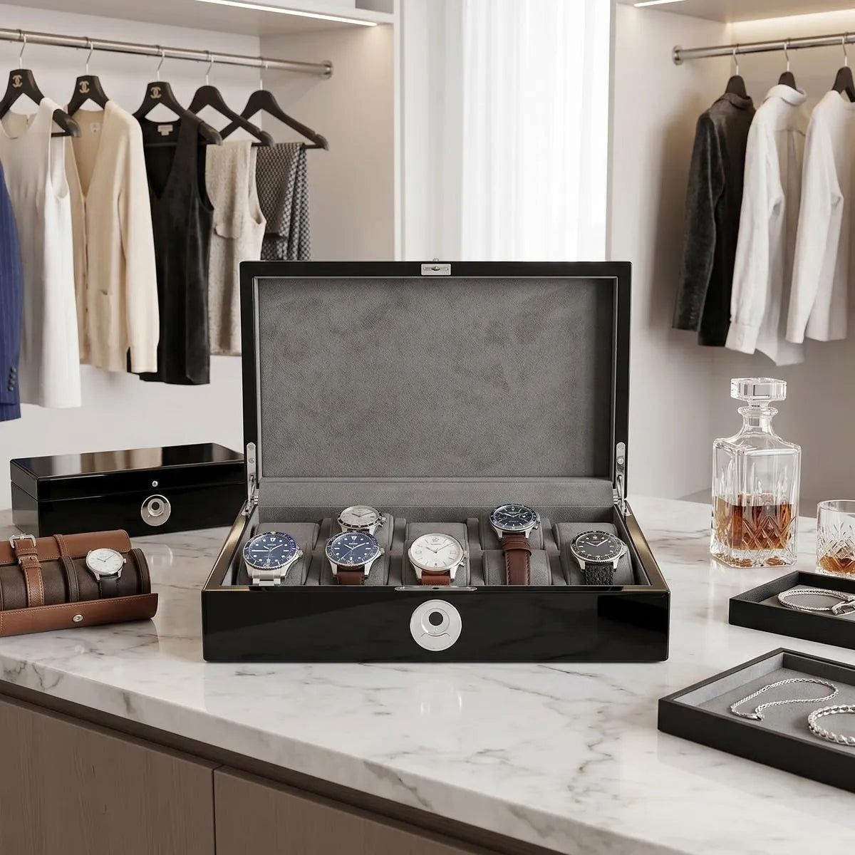 Front view of black piano finish Tempus 10 watch box with biometric lock in a bright luxurious walk-in dressing room, showcasing its sleek design.