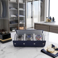 Close-up of navy blue saffiano leather watch roll with soft interior lining and three watch compartments in a bright walk-in dressing room.