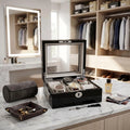 Close-up of a 6-watch black gloss finish box with grey lining in a modern dressing room on marble countertop