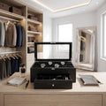 Elegant 22-watch box in black oak veneer with drawer, displayed in a bright, modern dressing room with luxury props.