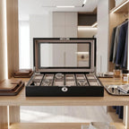 Elegant 12-watch box with black oak veneer finish displayed in a luxurious walk-in dressing room with jewelry trays and leather accessories.