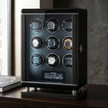 Sleek 9-watch winder for automatic watches with biometric lock, premium finish, digital touchscreen, and LED lighting in a luxury setting.