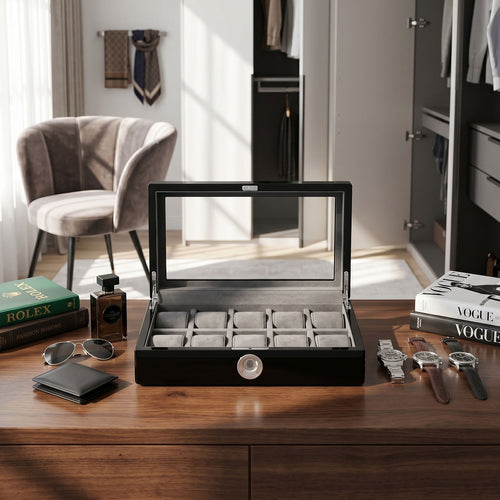 Stylish dressing room scene featuring a black piano finish watch box with glass lid and biometric lock, surrounded by modern accessories.