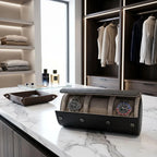 Close-up of the Tempus triple watch roll in carbon fibre leather on a marble countertop in a luxurious walk-in dressing room.