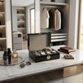 Full view of Tempus 8 watch box on dressing room vanity showing black finish, cushioned slots, and secure biometric lock, styled with luxury accessories.